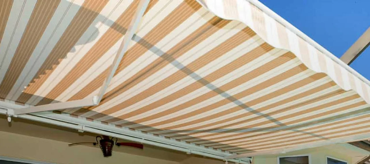 motorized retractable awning shading an outdoor patio