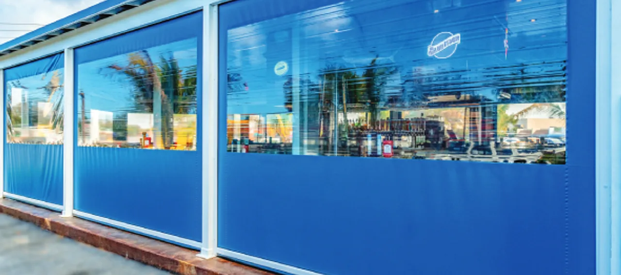 clear-view motorized exterior screens enclosing a poolside patio